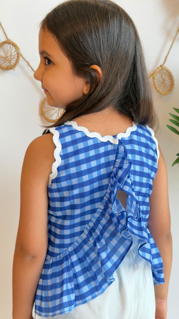 Back view of blue gingham peplum top with tie and ruffle detail