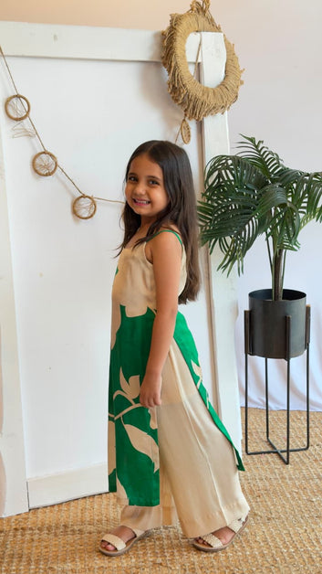 Side view of a girl wearing an emerald green and cream floral tunic with palazzo pants