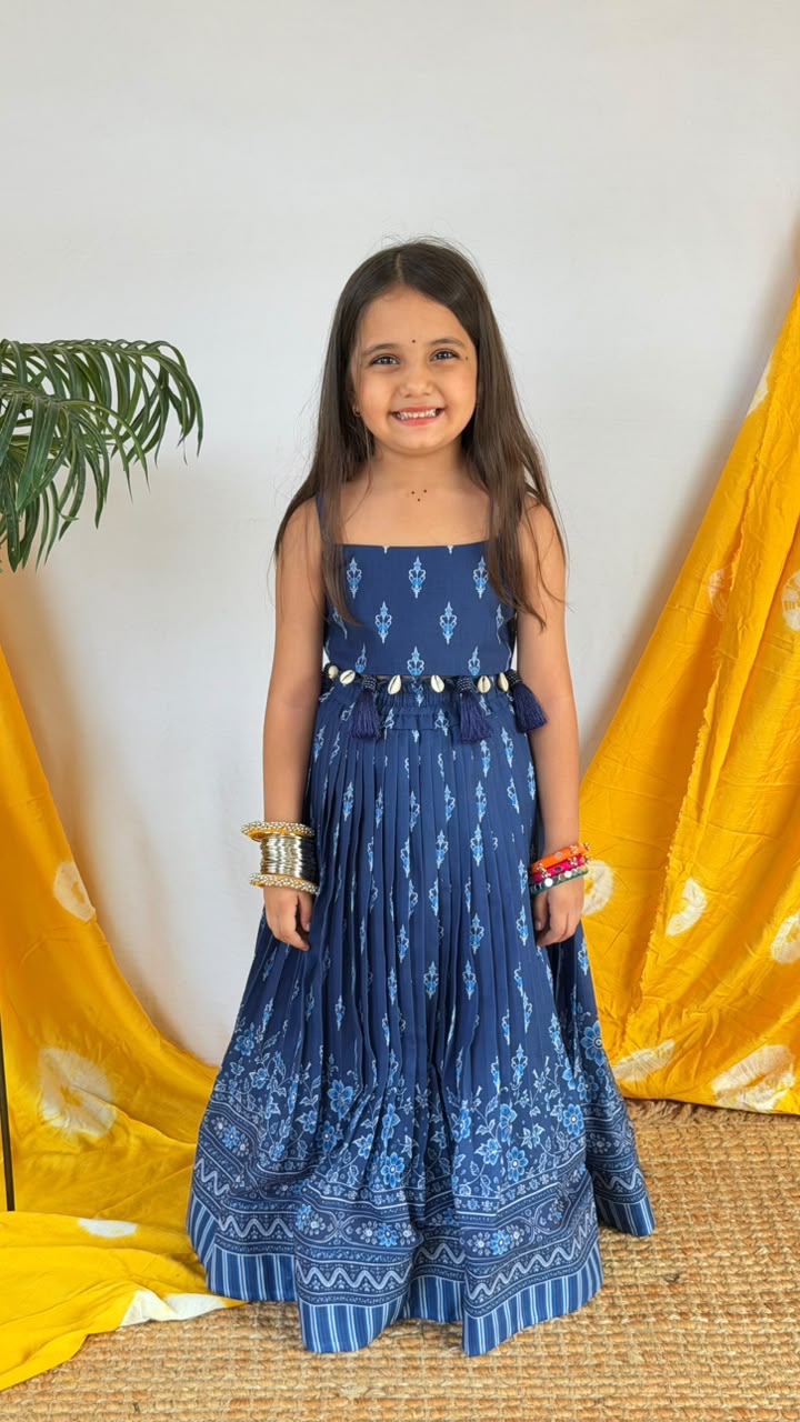 Back view of a navy blue girls’ lehenga choli set showing the printed bodice and full skirt