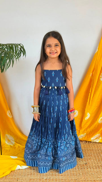 Back view of a navy blue girls’ lehenga choli set showing the printed bodice and full skirt