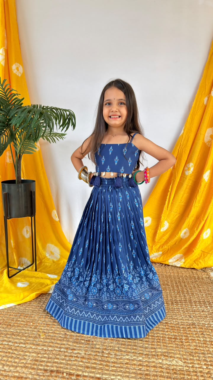 Front view of a girl wearing a navy blue printed lehenga choli set with a full-length patterned skirt