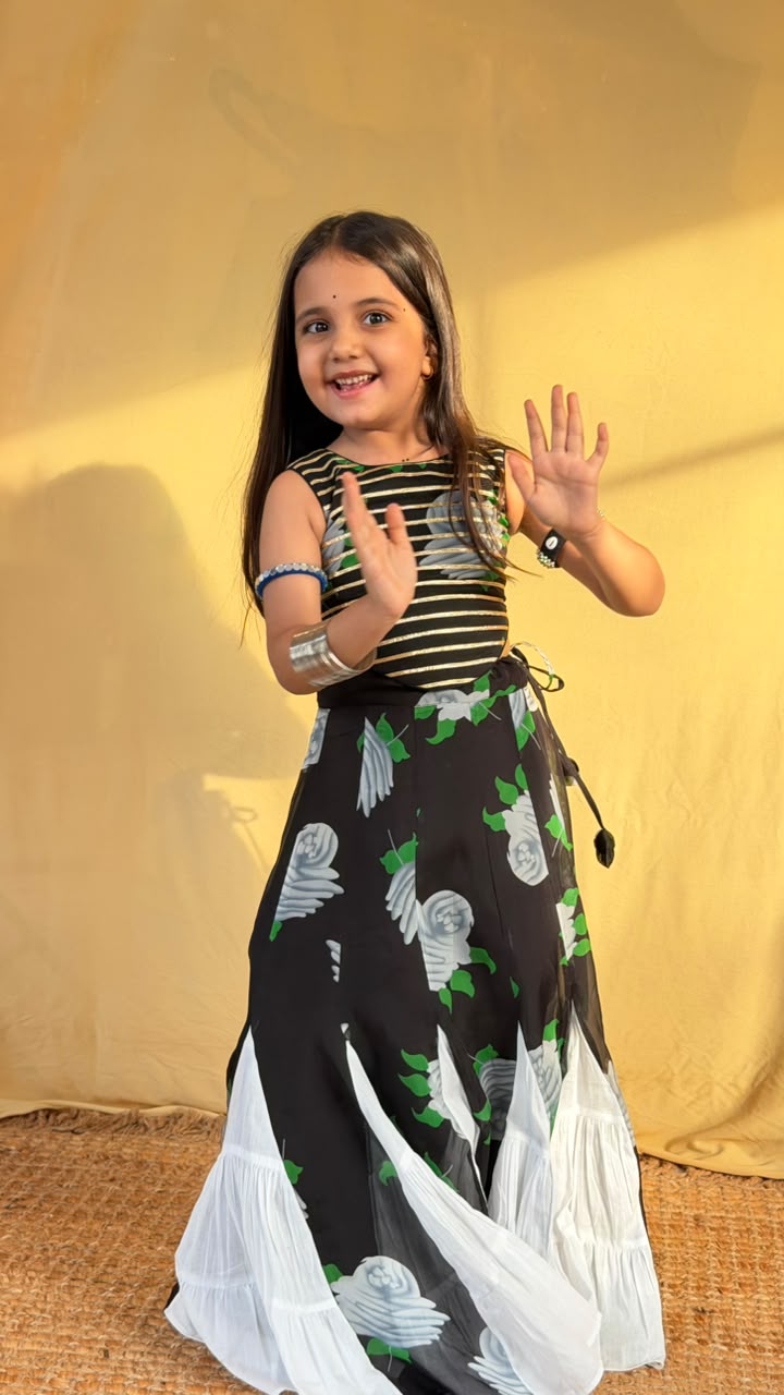Back view of the girls’ lehenga set showing its open criss-cross tie-up top and floral skirt