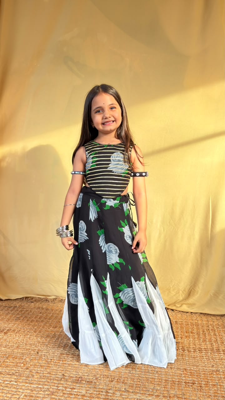 Front view showing the striped cropped top and floral skirt of the girls’ lehenga set